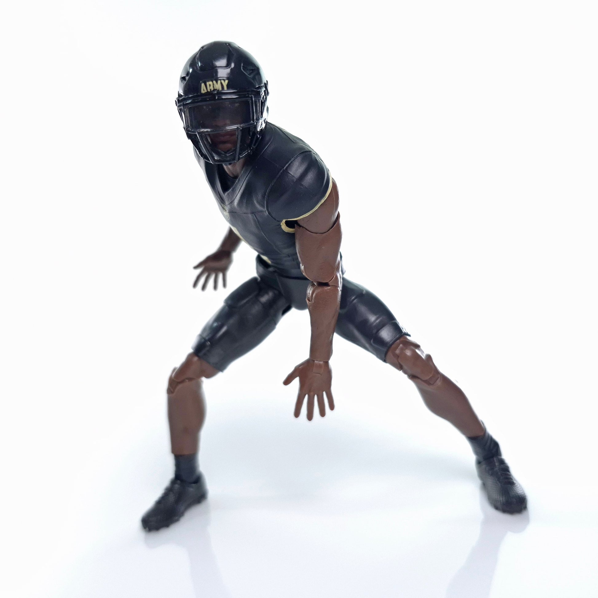 Collegiate Legends Army football action figure in a black and gold uniform with a helmet and articulated joints