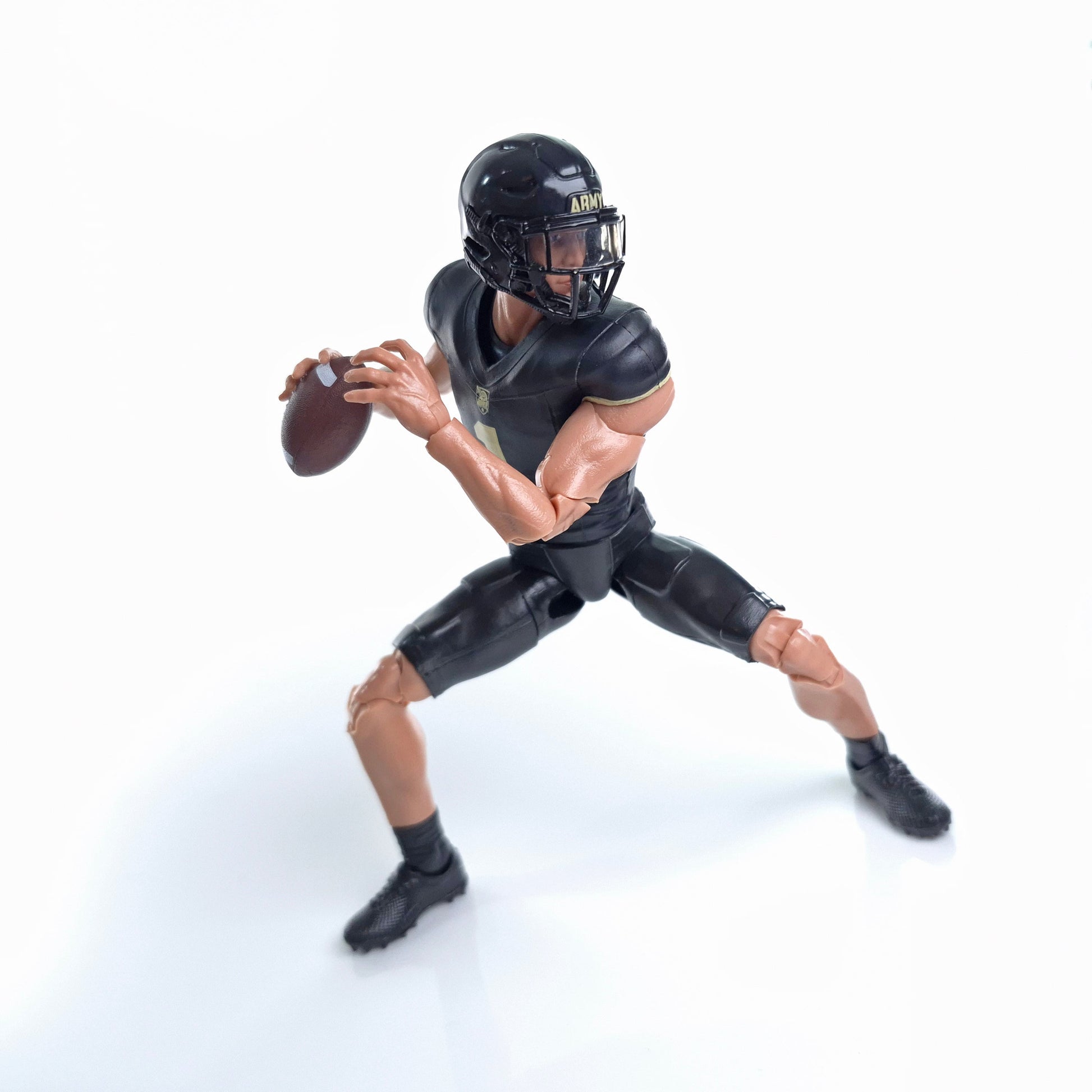 Collegiate Legends Army football action figure in black and gold uniform throwing a football in a dynamic pose