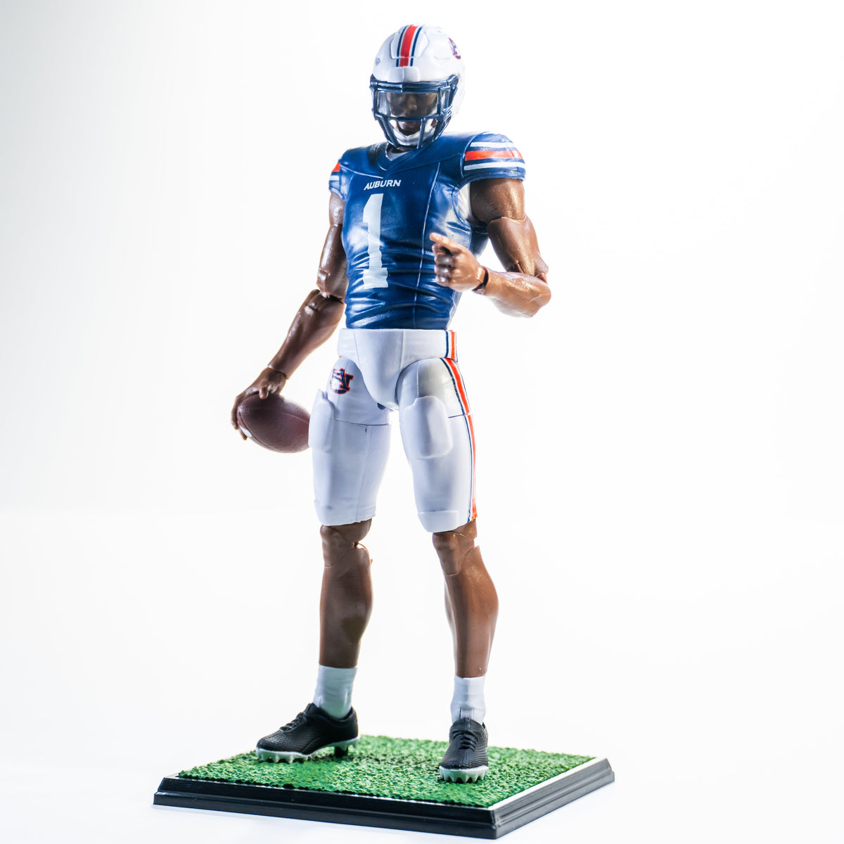 Collegiate Legends Auburn football action figure wearing a navy and orange number 1 jersey with a football accessory.