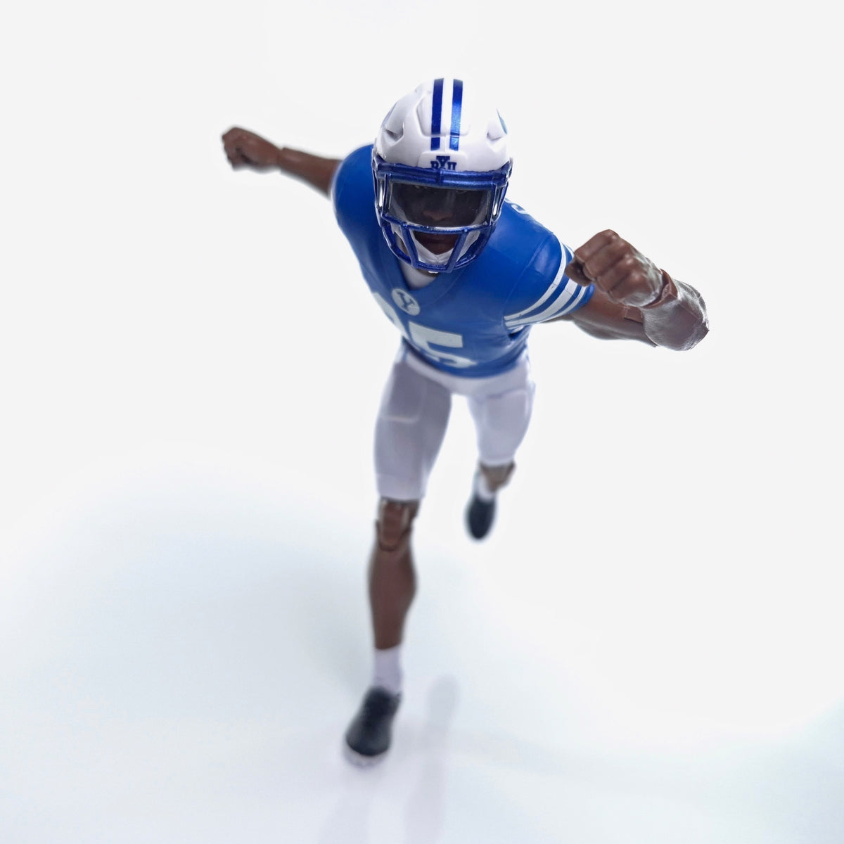 Collegiate Legends BYU #25 football action figure in a dynamic running pose wearing a blue and white team uniform.