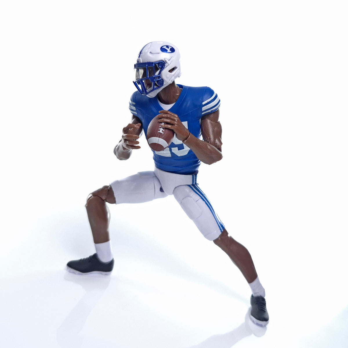 Collegiate Legends BYU football action figure in dark blue uniform with helmet and football in a throwing pose