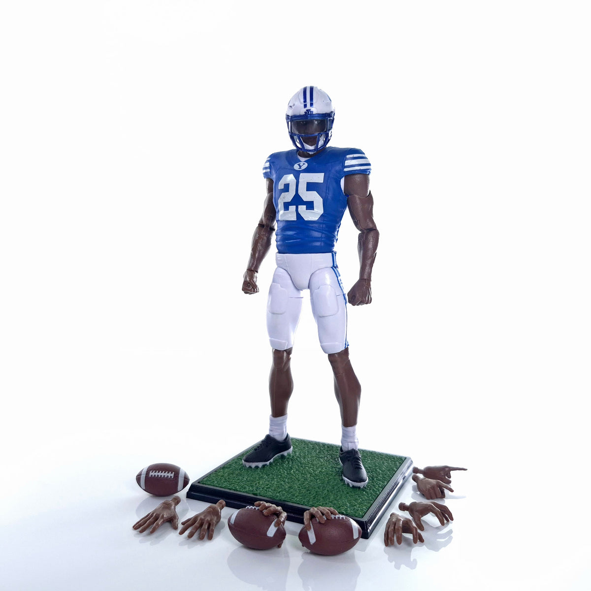 Collegiate Legends BYU #25 football action figure in blue uniform with display stand, footballs, and extra hands.