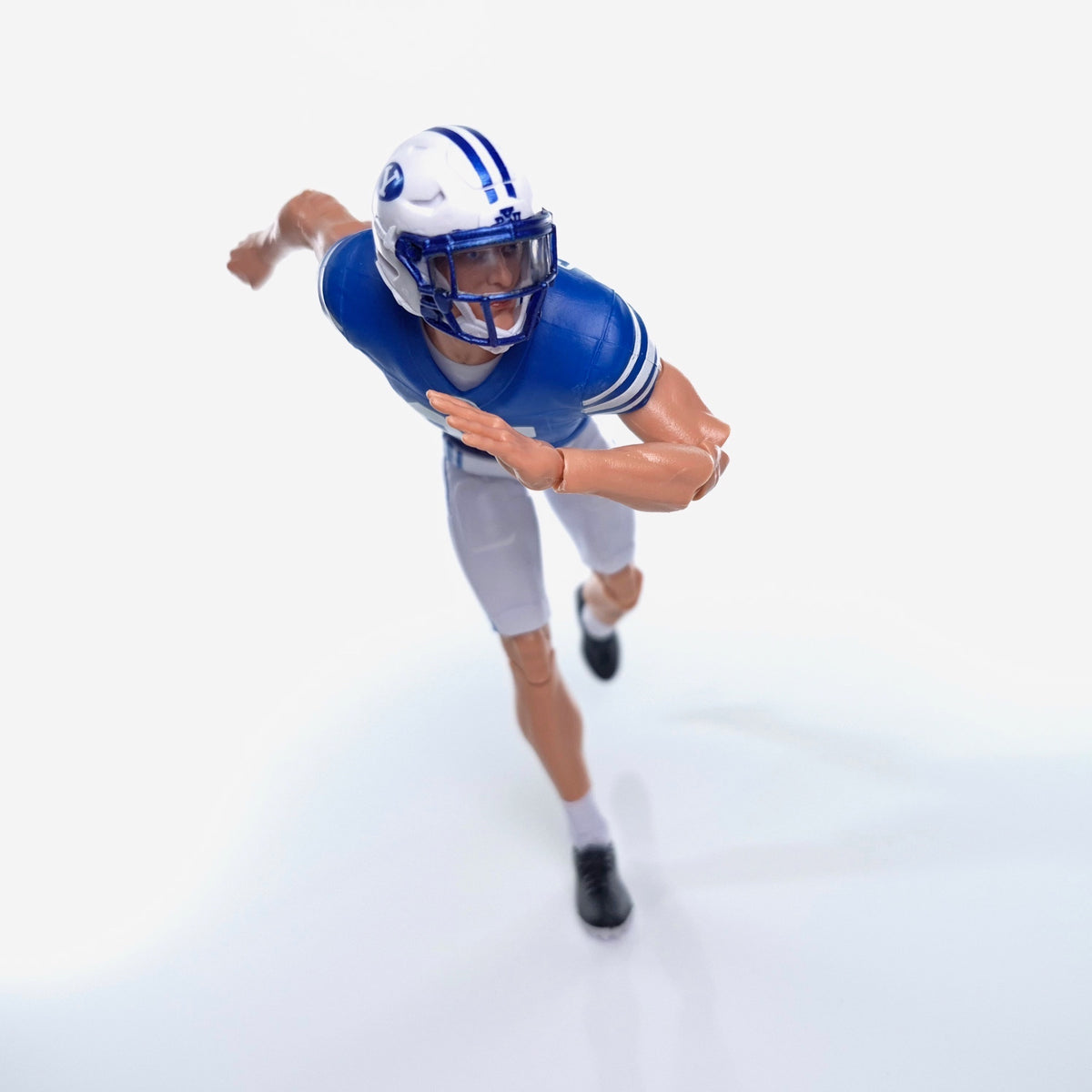 Collegiate Legends BYU football action figure in blue and white uniform running in a dynamic pose