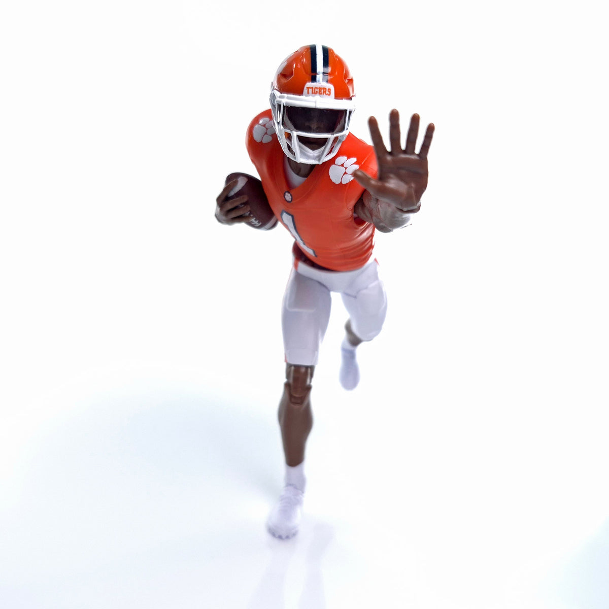 Collegiate Legends Clemson football action figure in orange jersey and helmet running with a football.
