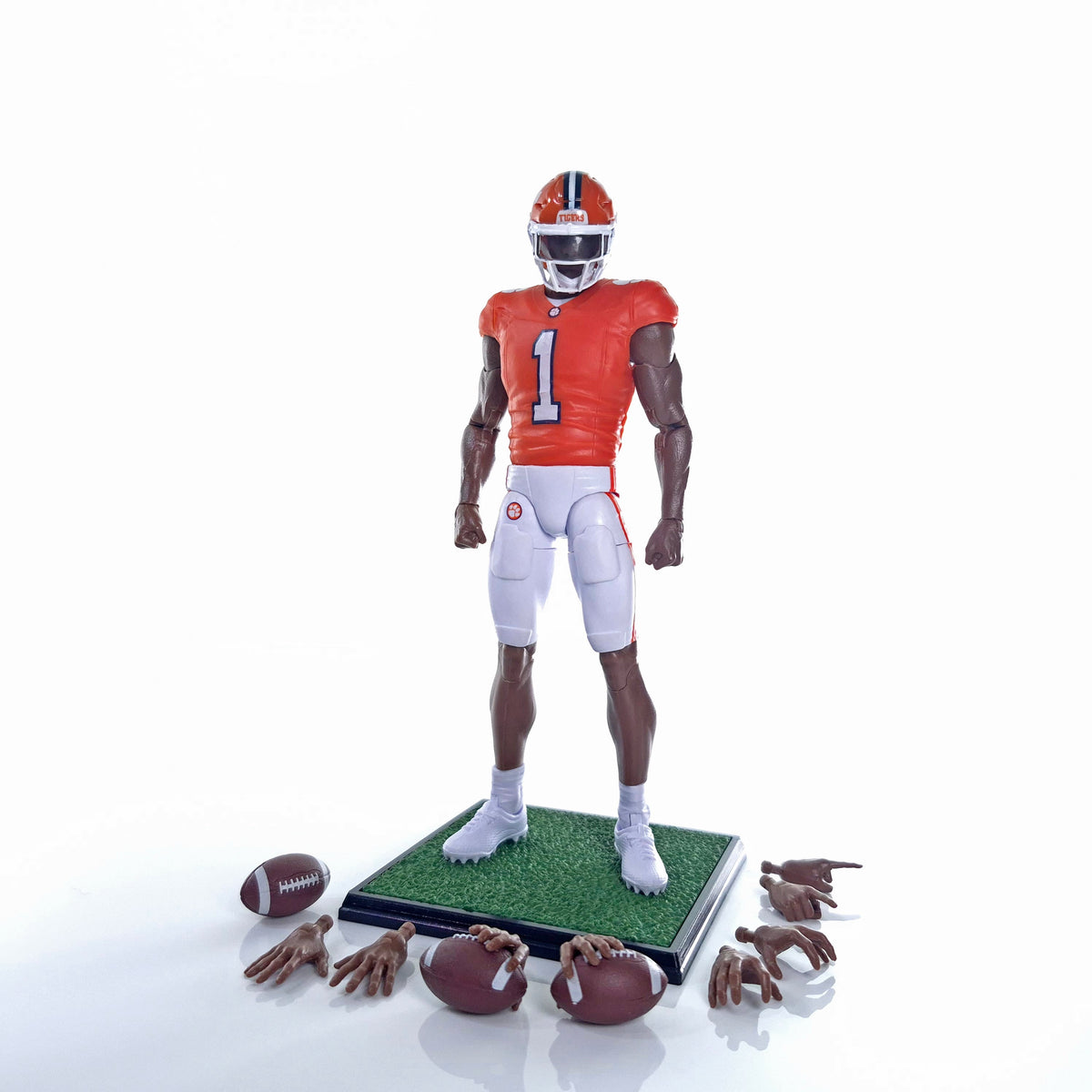Collegiate Legends Clemson football action figure in orange jersey with display stand, football, and hand accessories.