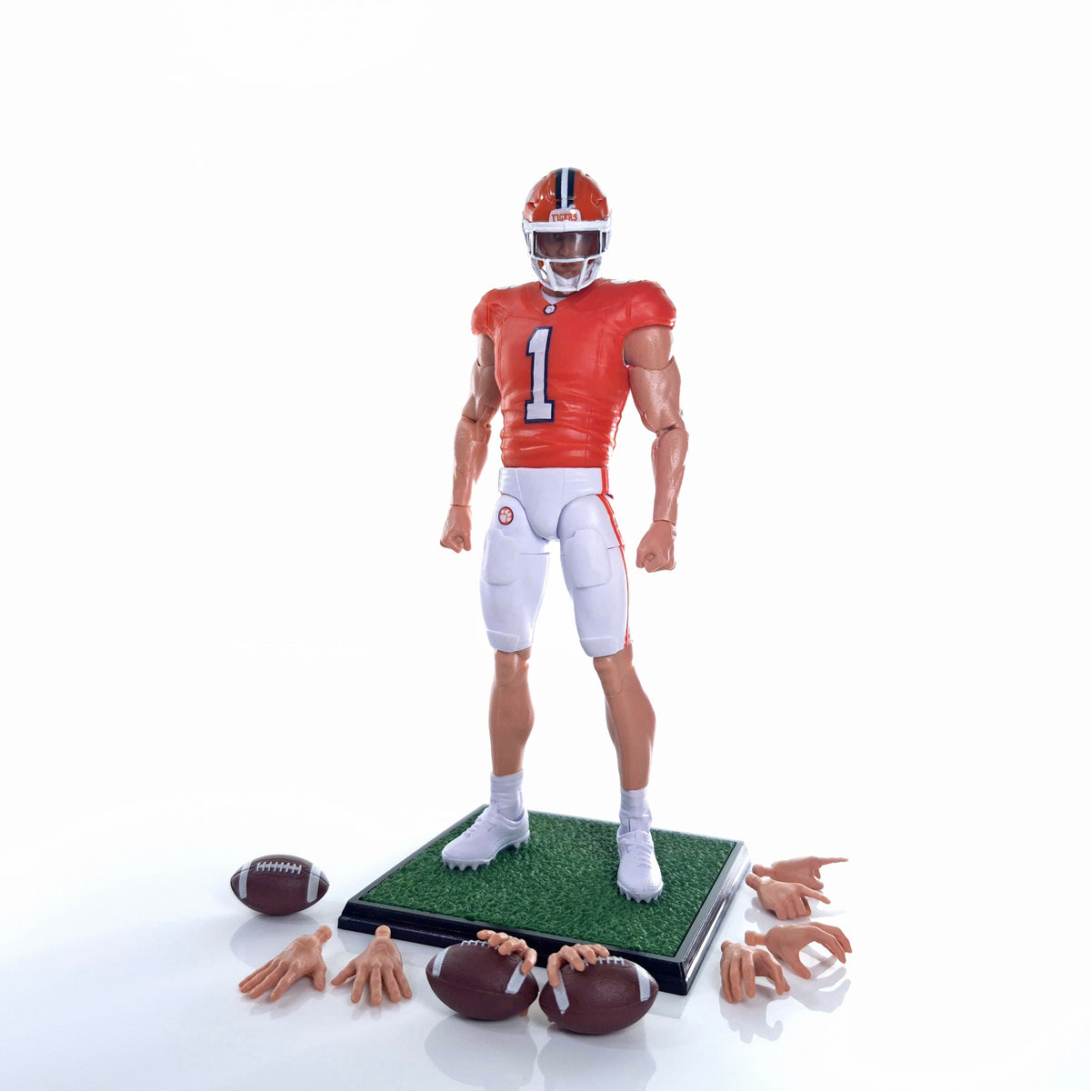Collegiate Legends Clemson football action figure in orange jersey with display stand, footballs, and extra hands.