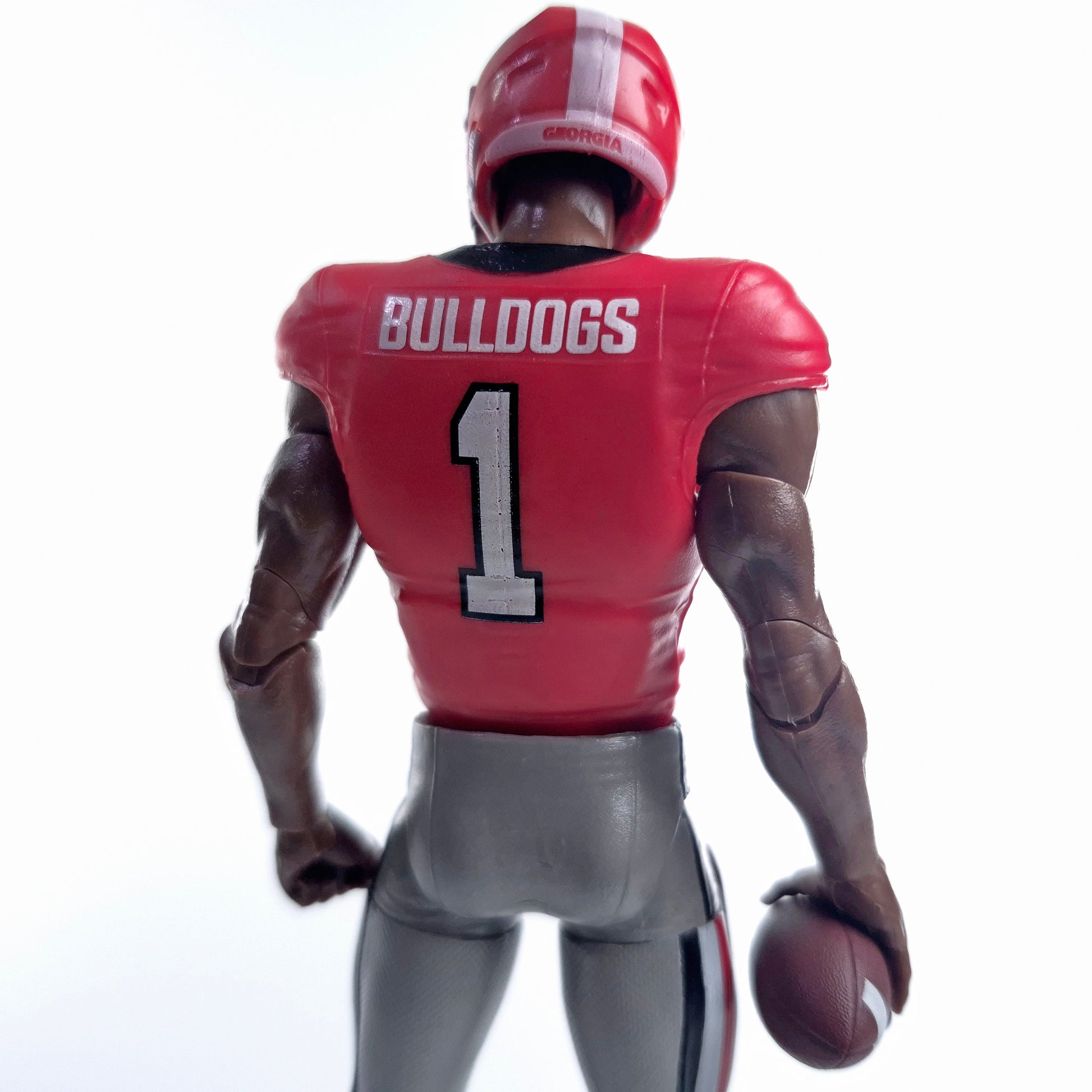 Collegiate Legends Georgia Bulldogs #1 football action figure in red jersey holding a football, back view