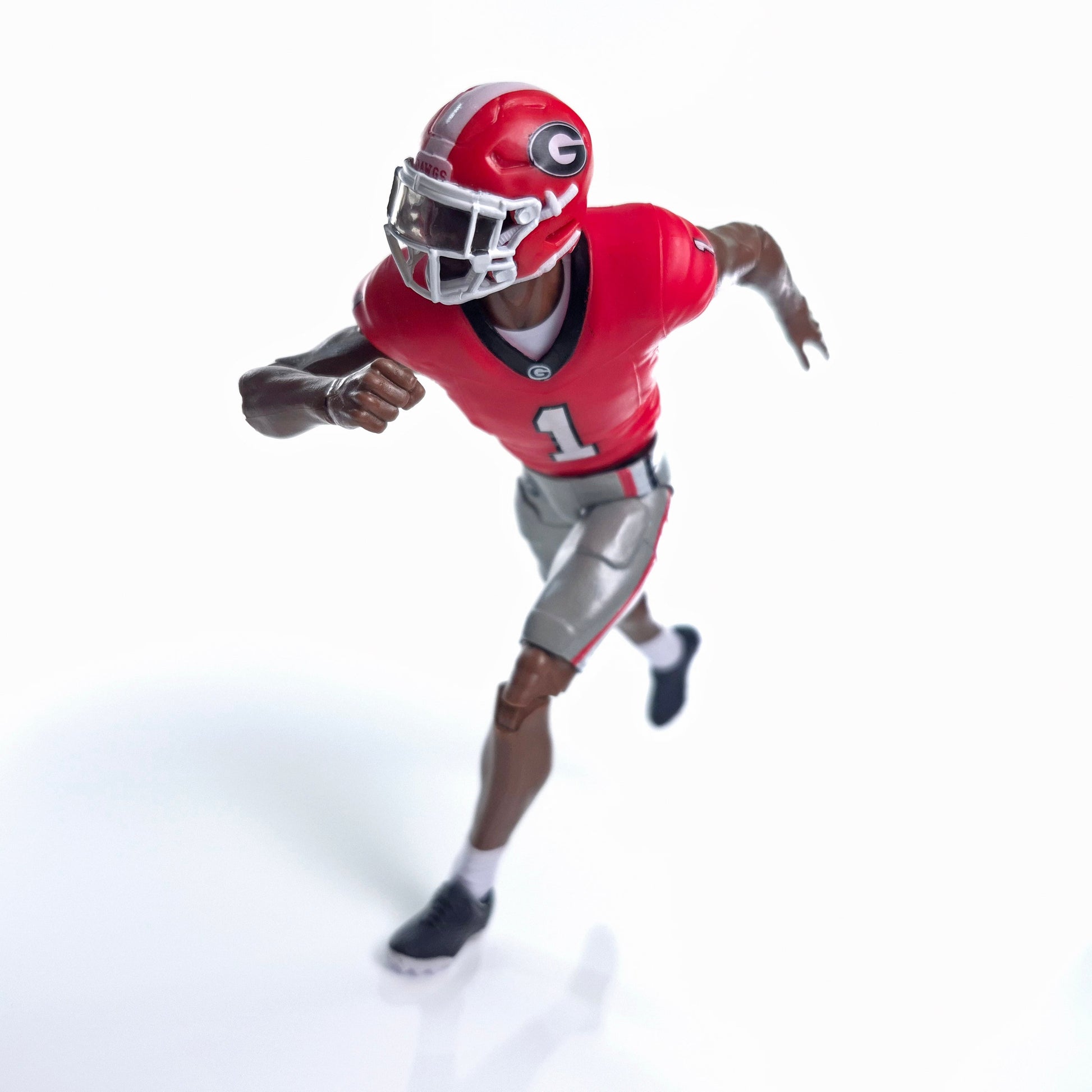 Collegiate Legends Georgia football action figure in a running pose wearing a red and black #1 jersey and helmet.