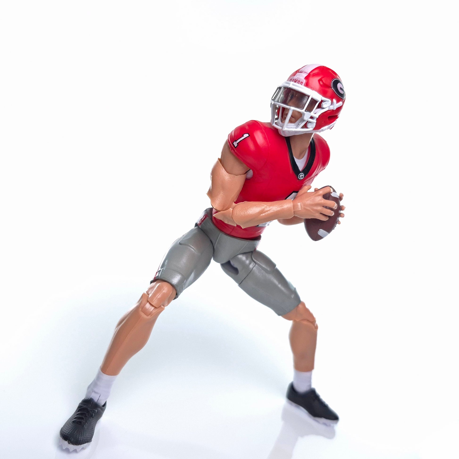 Collegiate Legends Georgia football action figure in red jersey with number 1, holding a football in a game pose.
