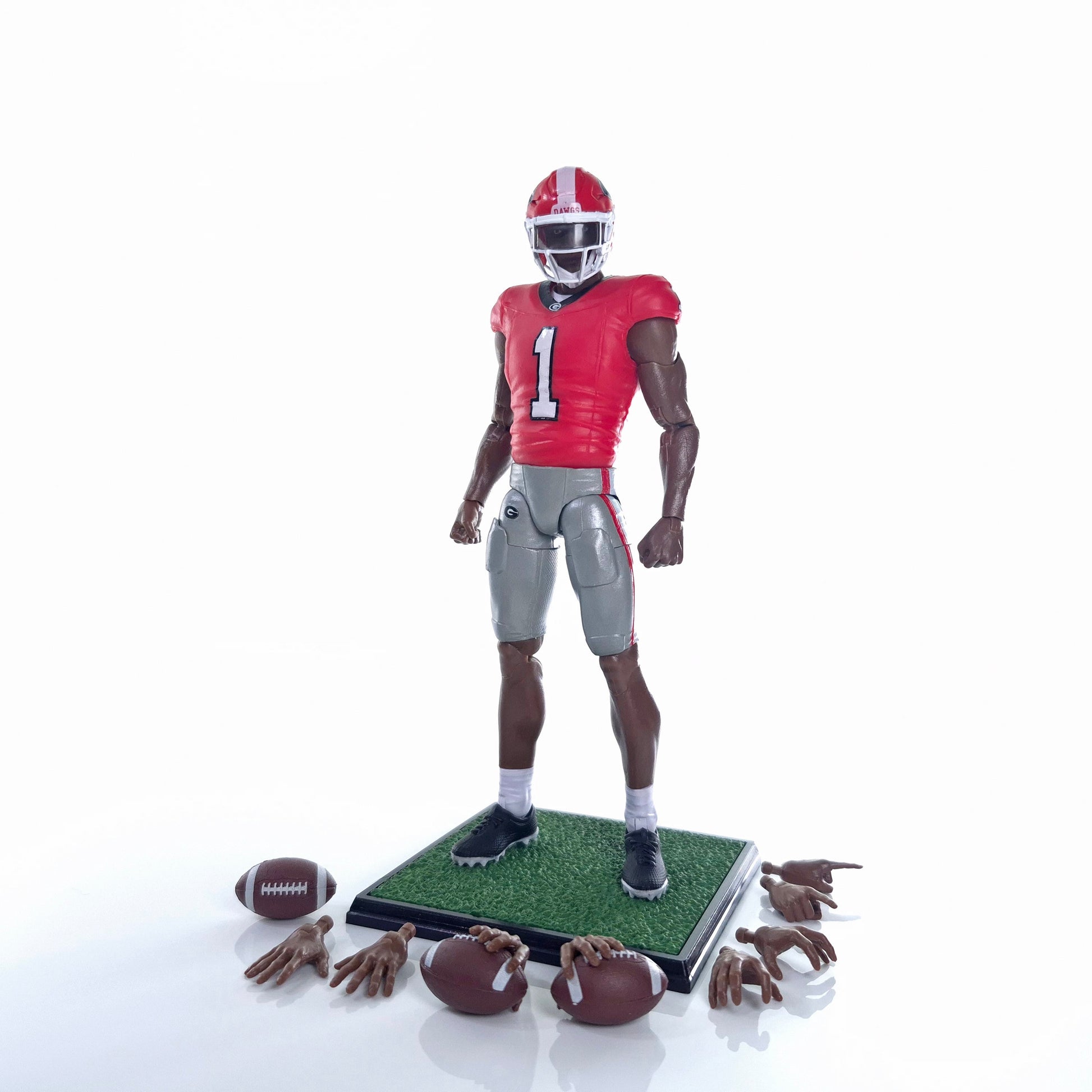 Collegiate Legends Georgia football action figure in red and black jersey with display stand, football, and accessories