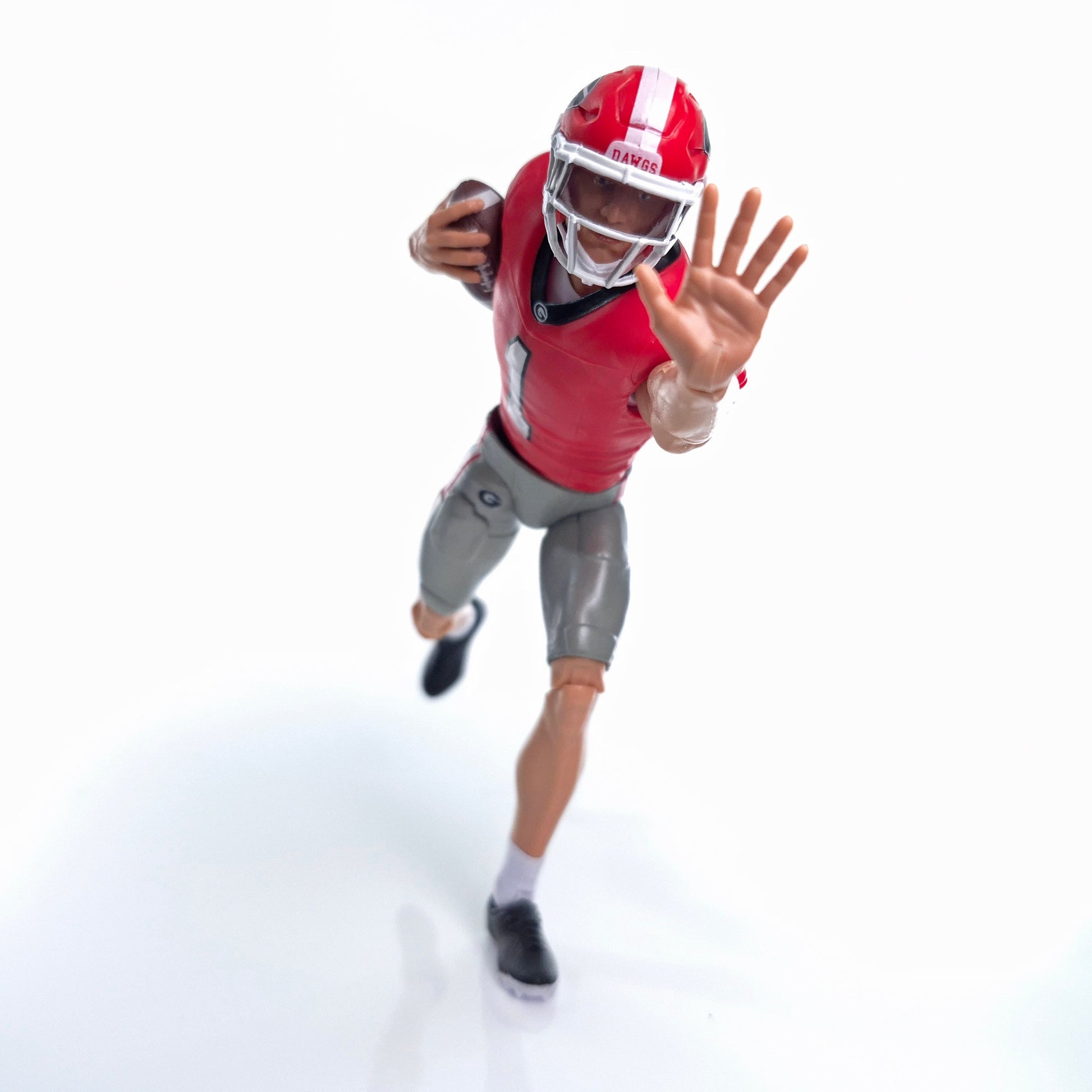 Collegiate Legends Georgia Bulldogs #1 football action figure in red and black uniform running with a football