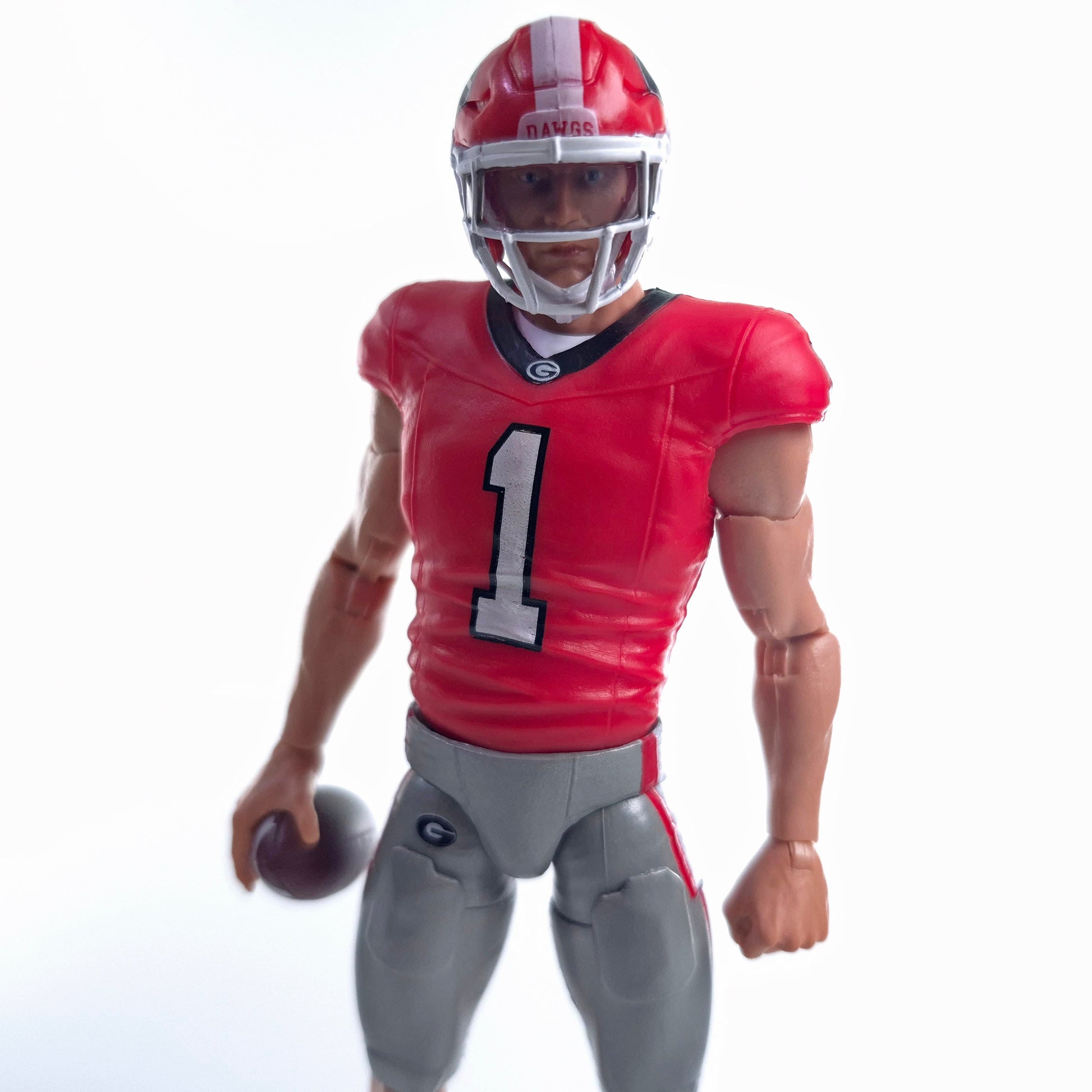 Collegiate Legends Georgia Bulldogs #1 football action figure in red and black uniform holding a football
