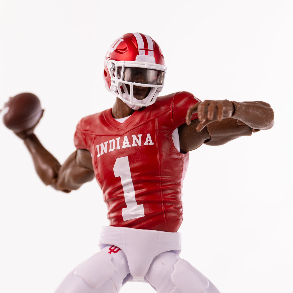 Collegiate Legends Indiana football action figure with dark skin tone, wearing a red jersey and throwing a football.