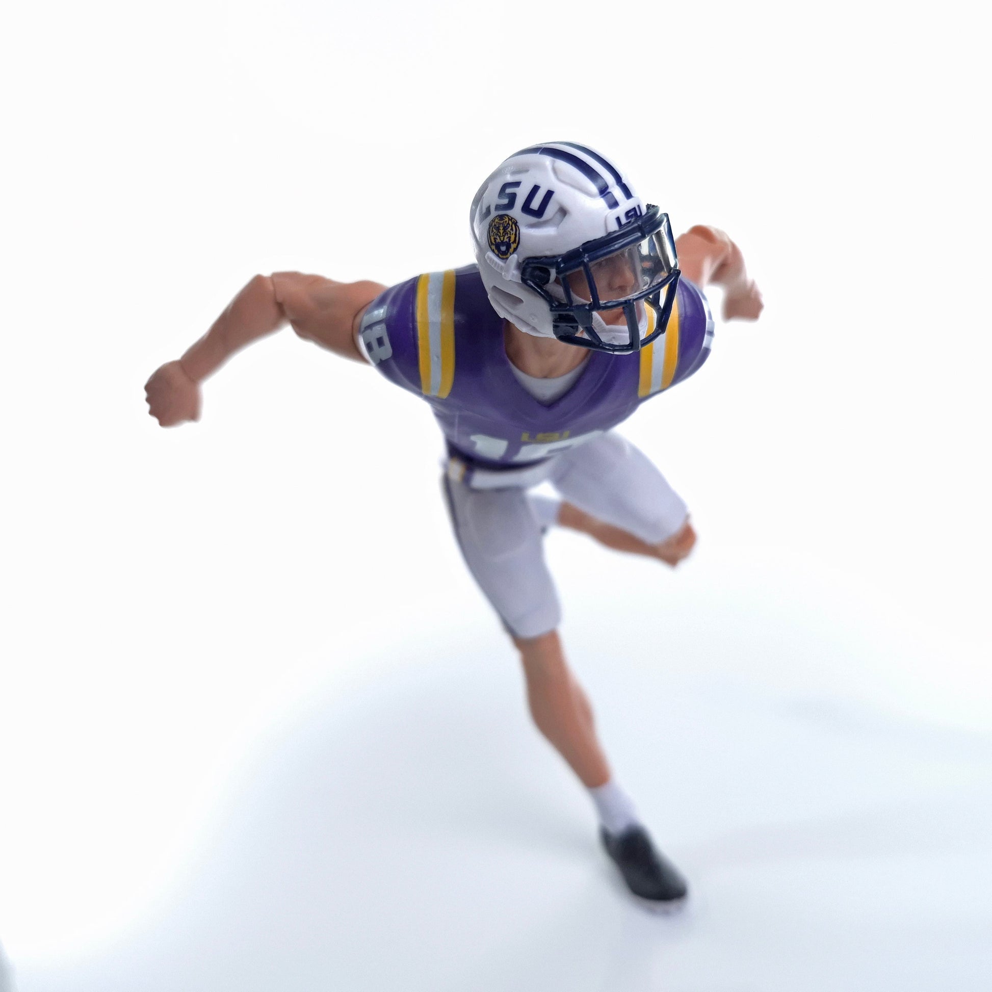 Collegiate Legends LSU football action figure in purple and gold uniform running in a dynamic pose