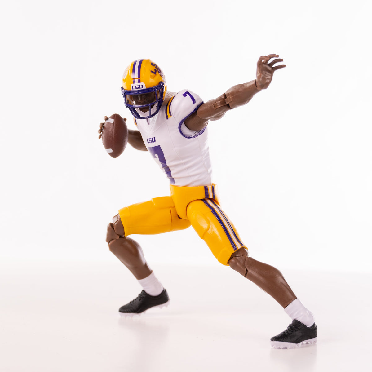 Collegiate Legends LSU #7 football action figure in white and yellow uniform throwing a football in a dynamic pose