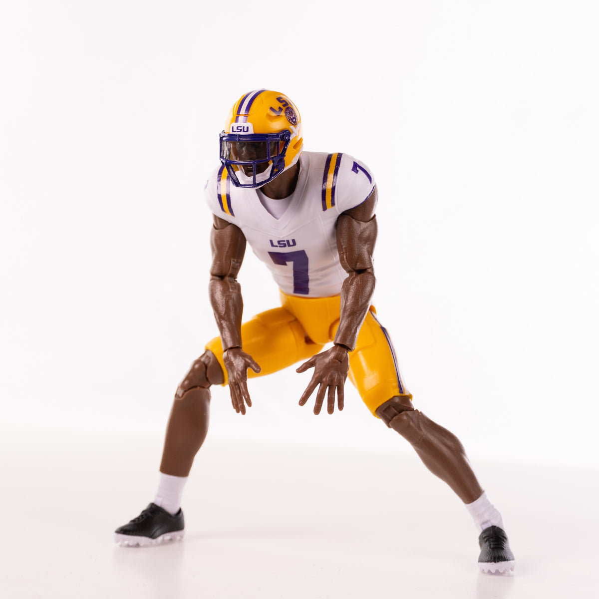 Collegiate Legends LSU #7 football action figure in white and yellow uniform posed in a defensive stance