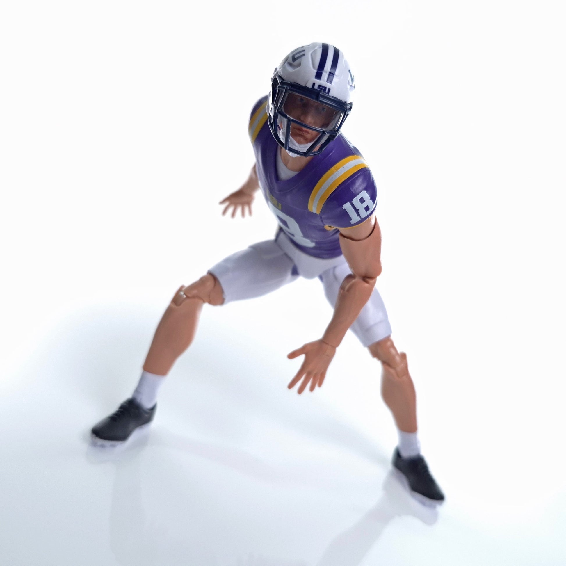Collegiate Legends LSU #18 football action figure in purple and gold uniform posed in a dynamic athletic stance