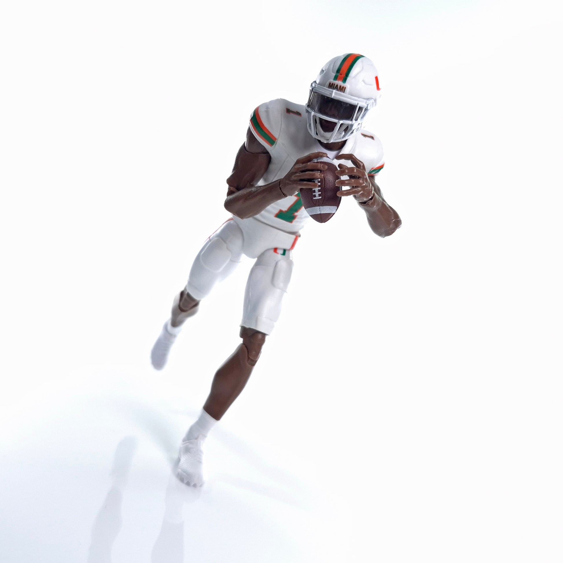 Collegiate Legends Miami football action figure in white uniform with orange and green details holding a football