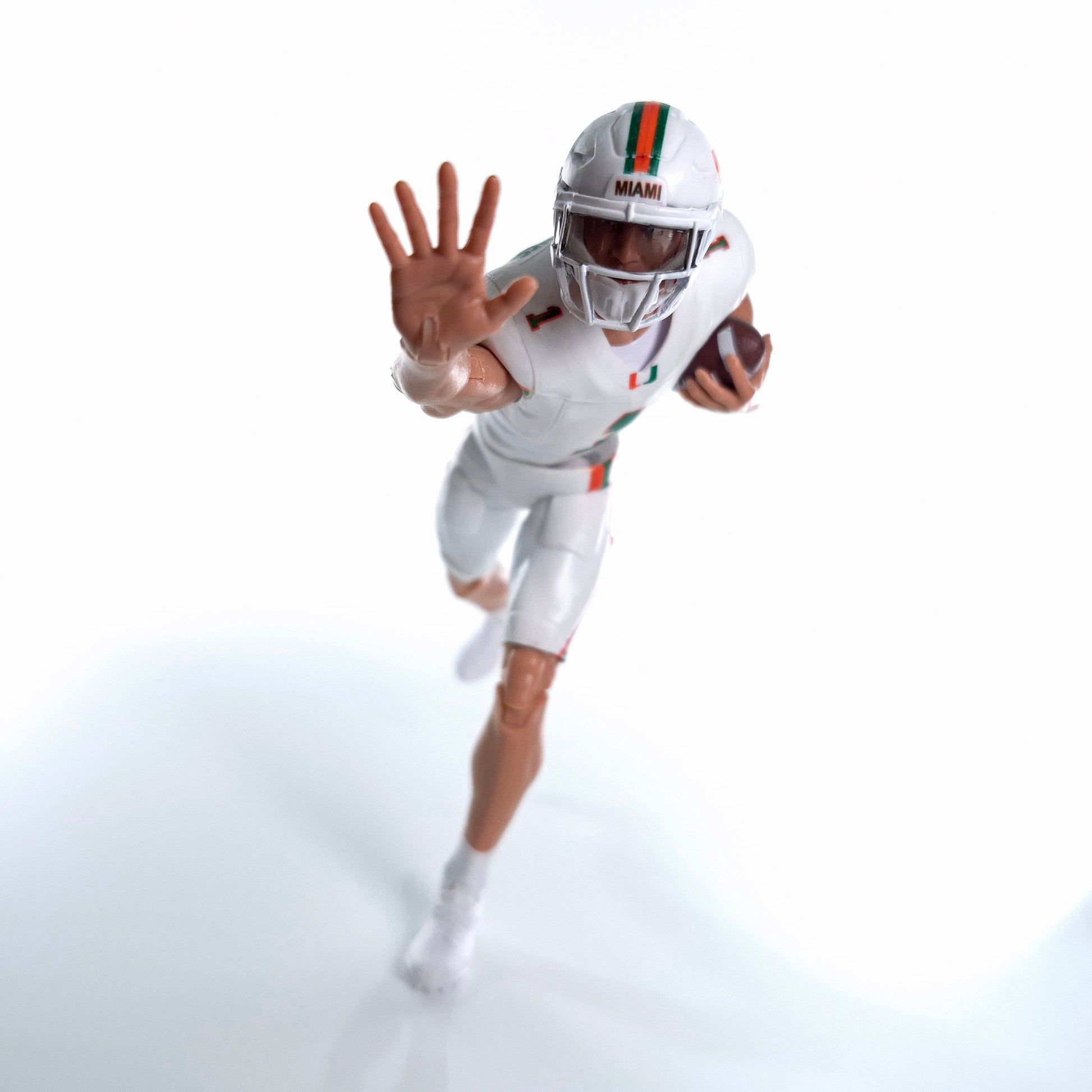 Collegiate Legends Miami Hurricanes football action figure in white uniform with #1 jersey and football accessory