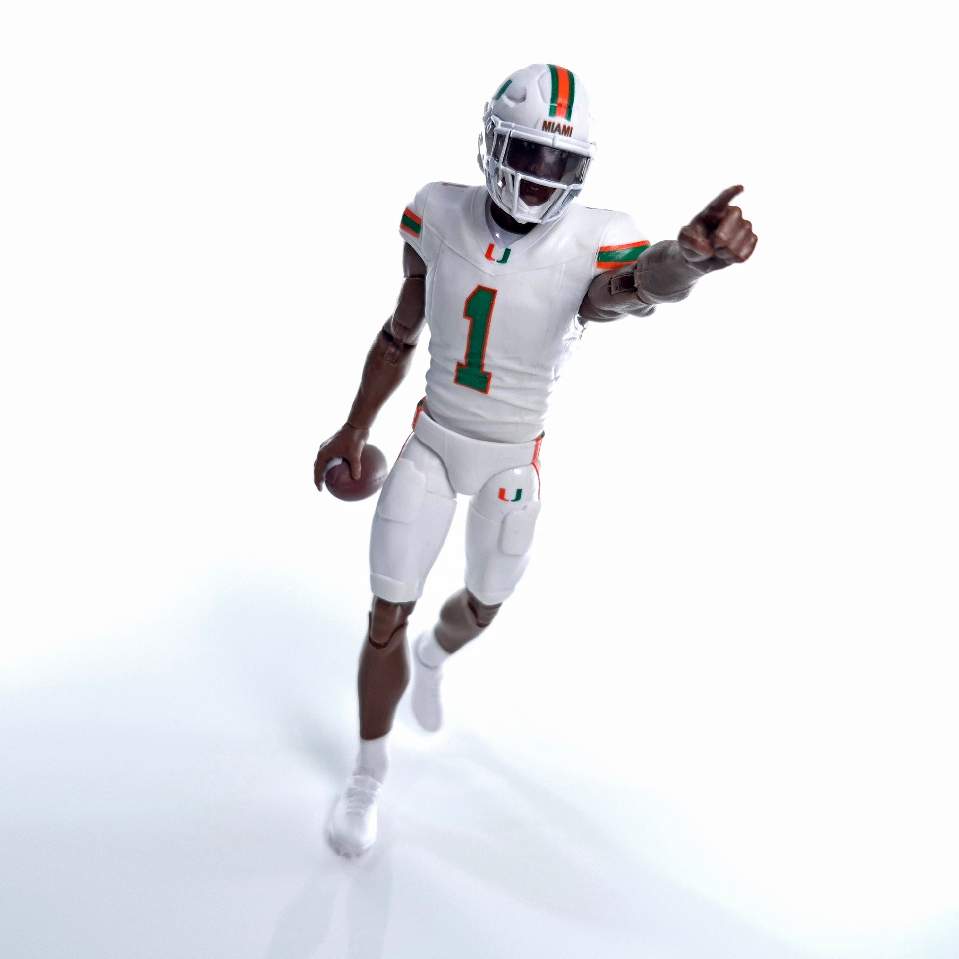 Collegiate Legends Miami Hurricanes #1 football action figure in white uniform pointing forward with a football