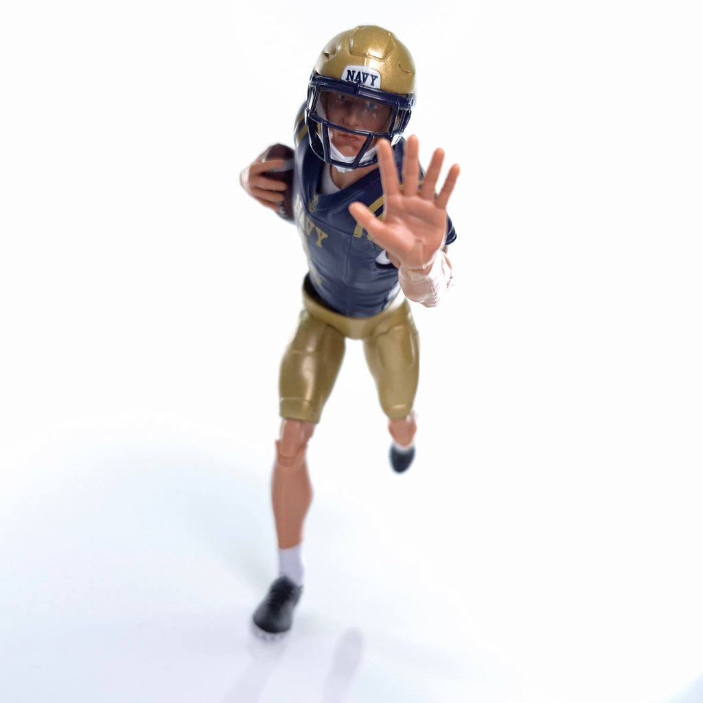 Collegiate Legends Navy football player action figure in blue and gold uniform with helmet, running with a football