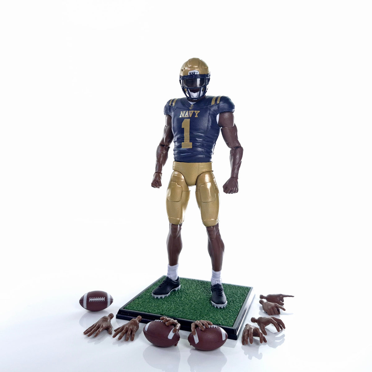 Collegiate Legends Navy football action figure with #1 jersey, gold helmet, display stand, and interchangeable hands.