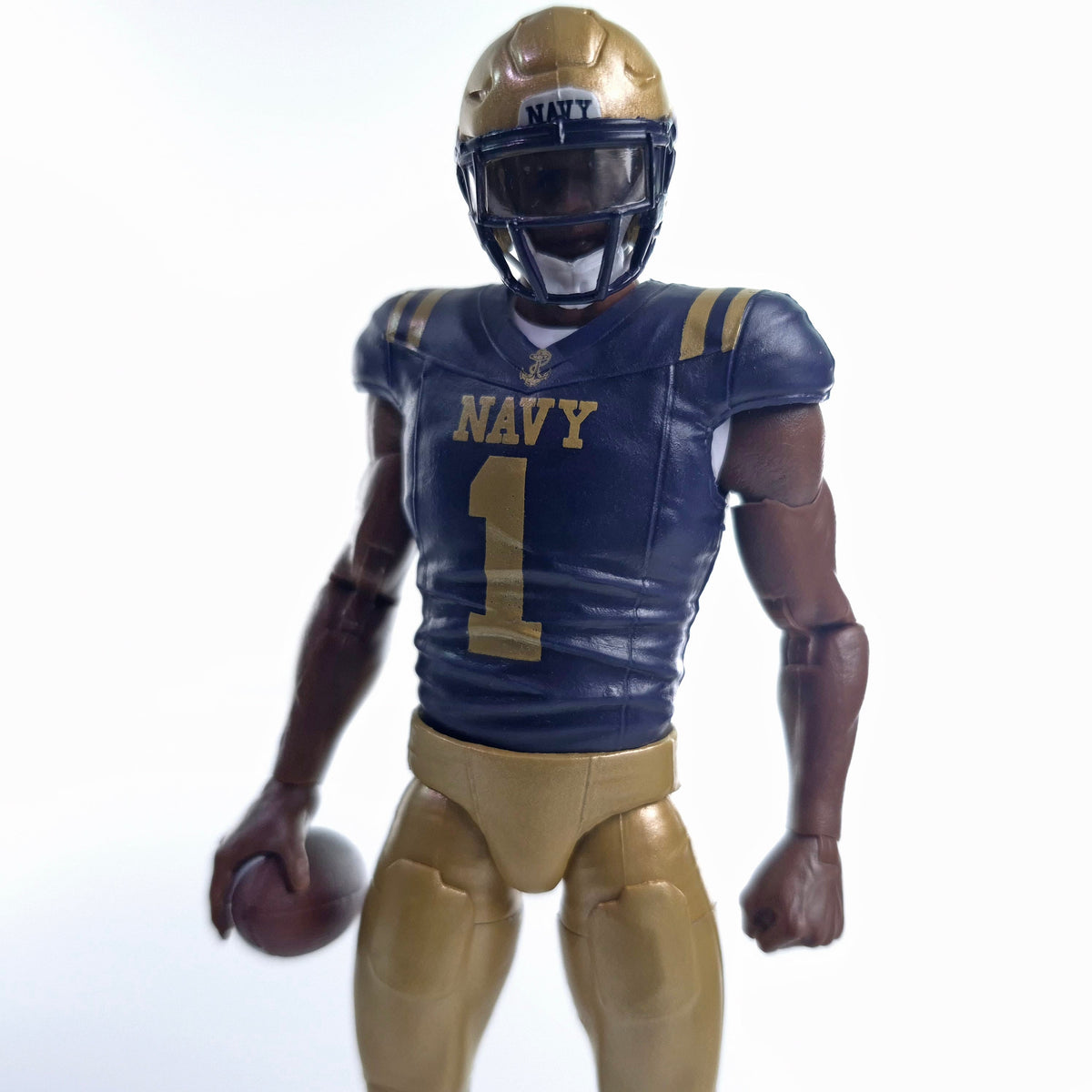 Collegiate Legends Navy football action figure wearing a blue and gold #1 jersey with a helmet and football accessory