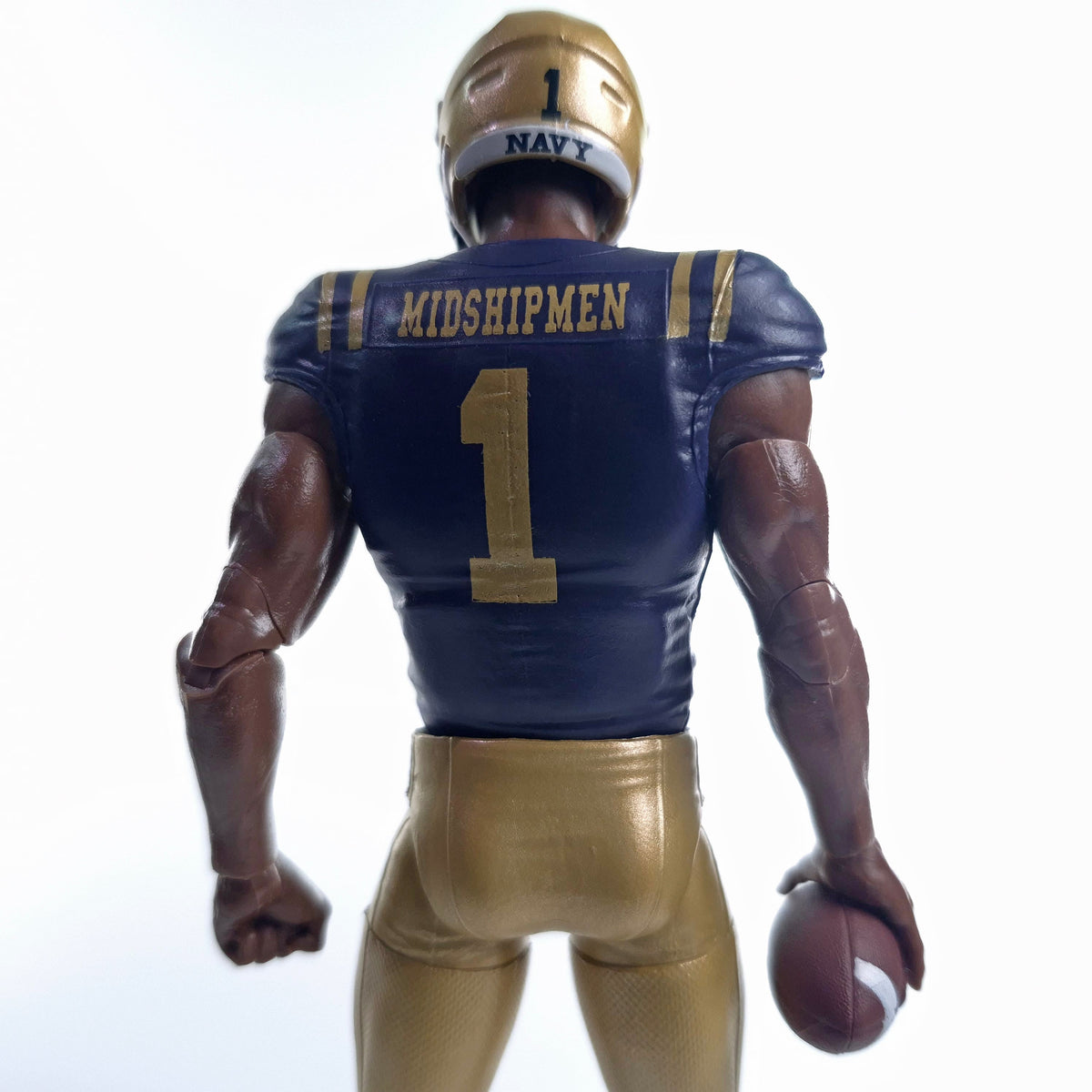 Collegiate Legends Navy Midshipmen #1 football action figure in blue and gold uniform, rear view holding a football.