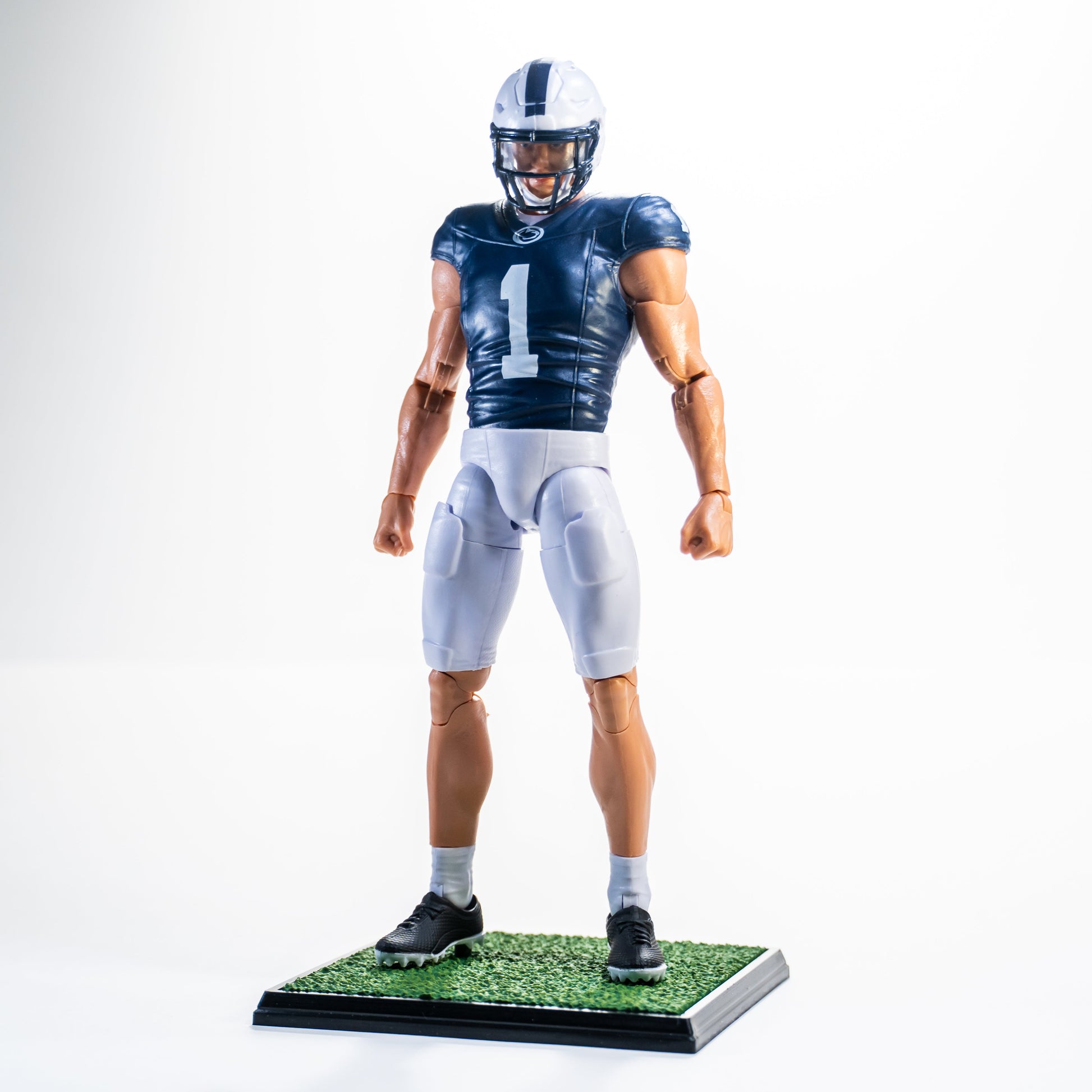 Collegiate Legends Penn State #1 football action figure in blue and white uniform standing on a grass display base.