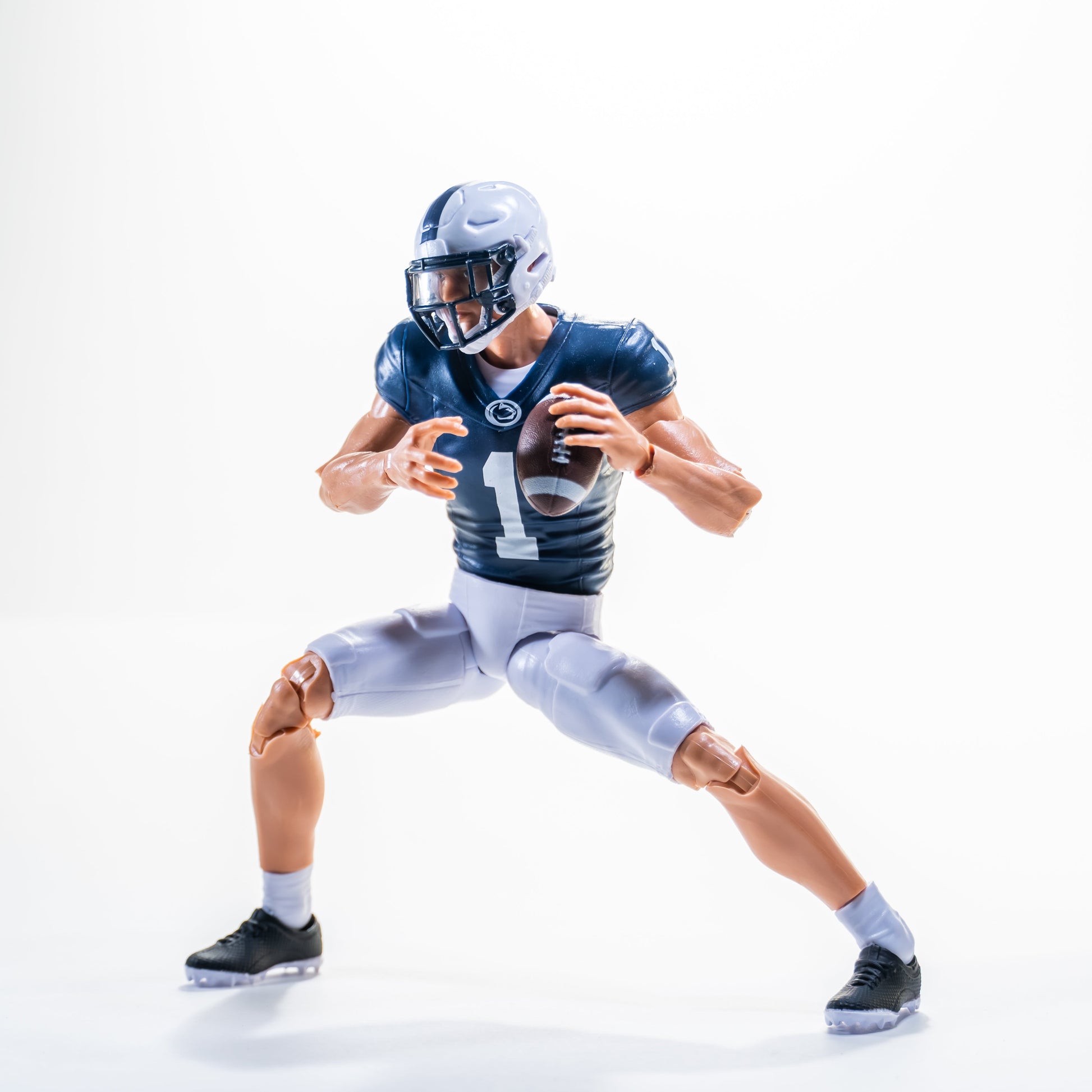 Collegiate Legends Penn State football action figure in a #1 blue and white jersey holding a football in a game pose