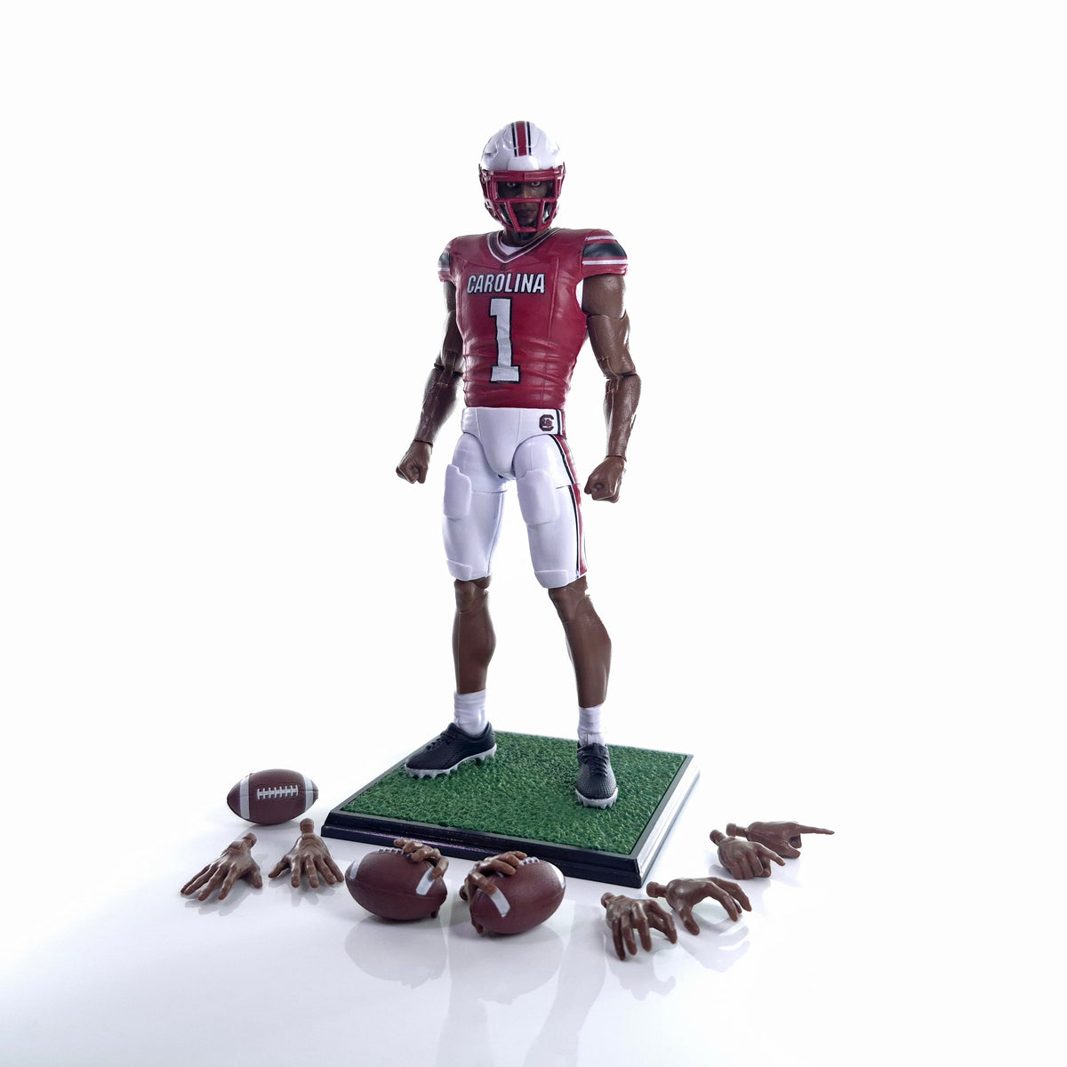 Collegiate Legends South Carolina #1 football action figure in garnet and white uniform with accessories on a stand