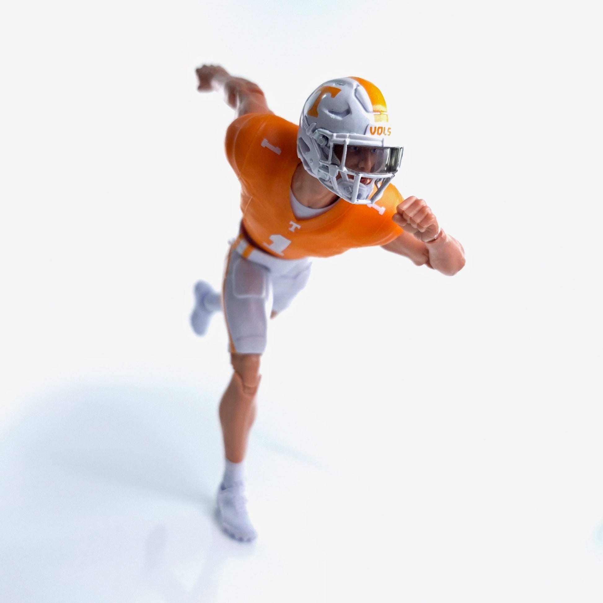 Collegiate Legends Tennessee football action figure in orange and white uniform running in a dynamic pose