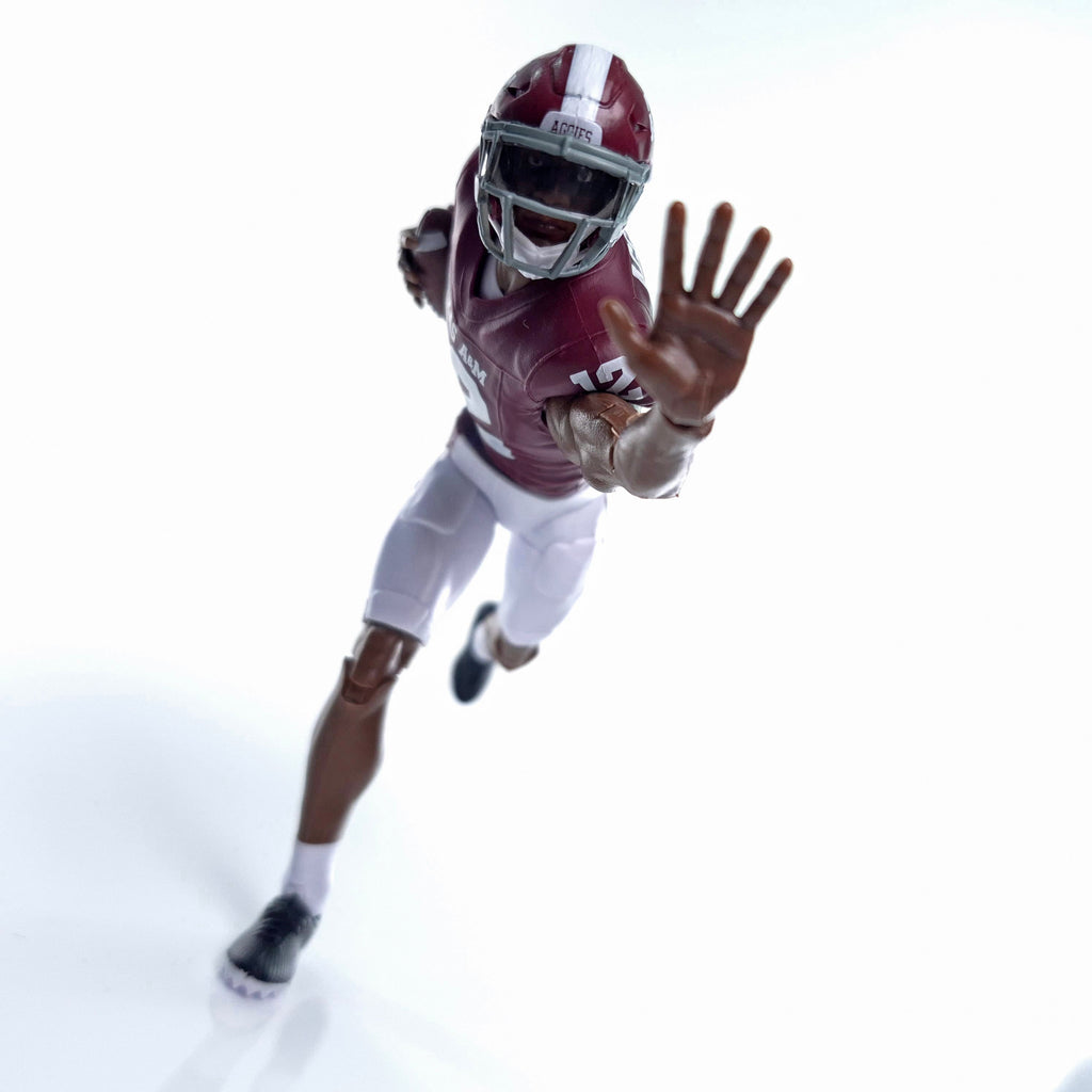 Collegiate Legends Texas A&M football action figure in maroon and white uniform reaching forward in a running pose