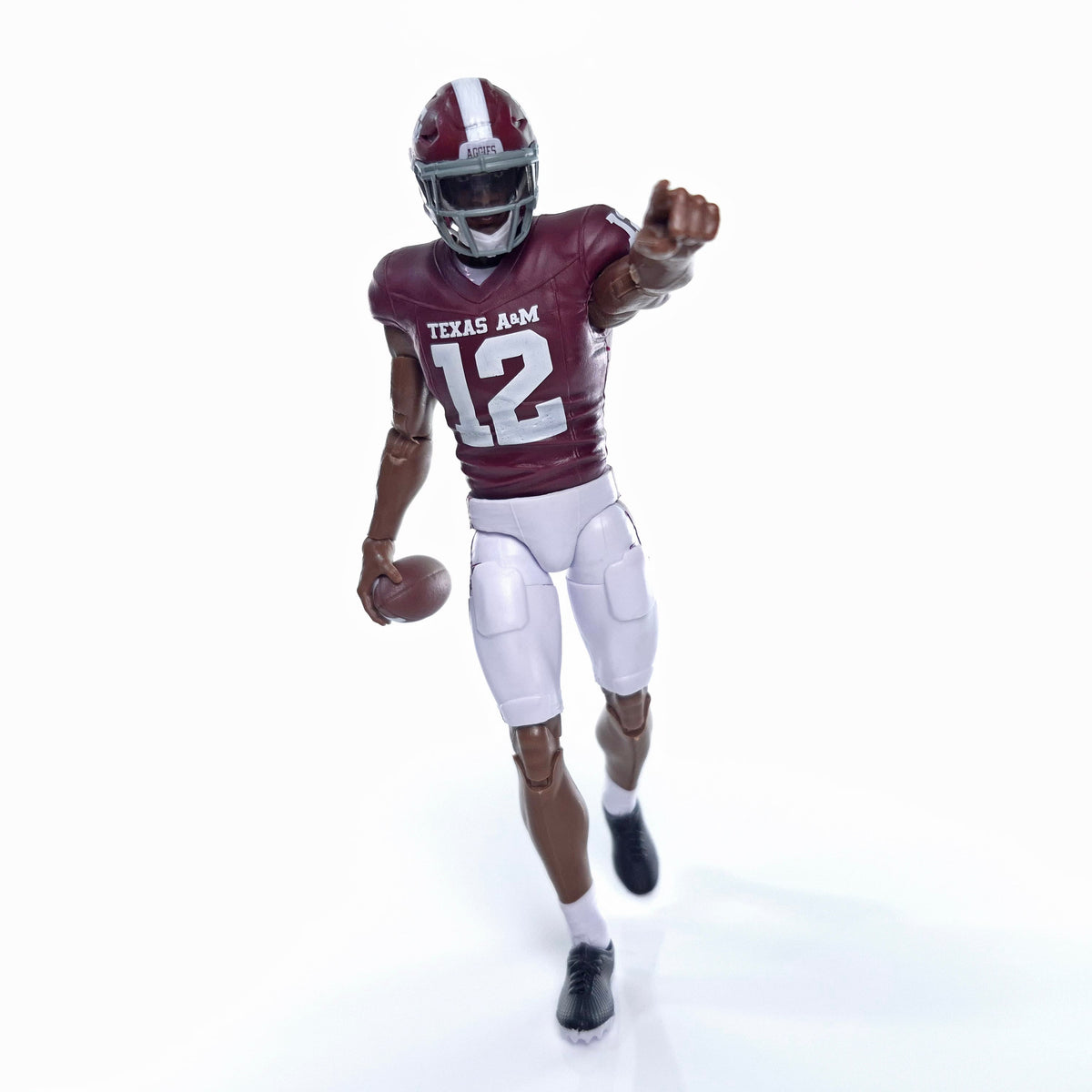 Collegiate Legends Texas A&M #12 football action figure in maroon and white uniform pointing forward with a football