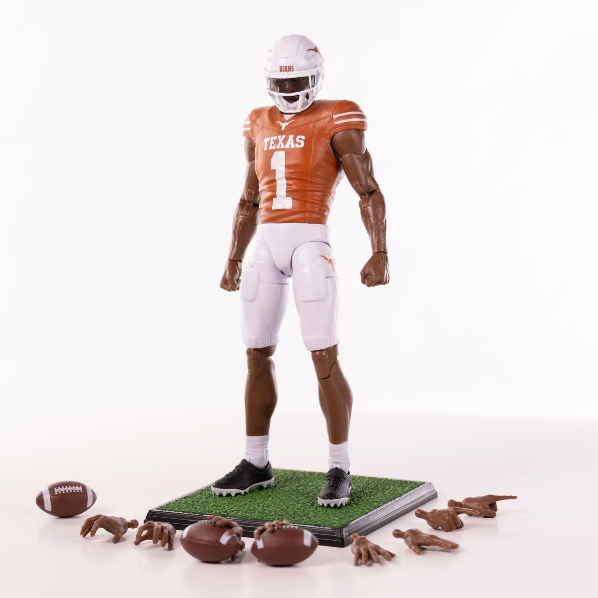 Collegiate Legends Texas football action figure wearing a burnt orange #1 jersey with display stand and accessories.