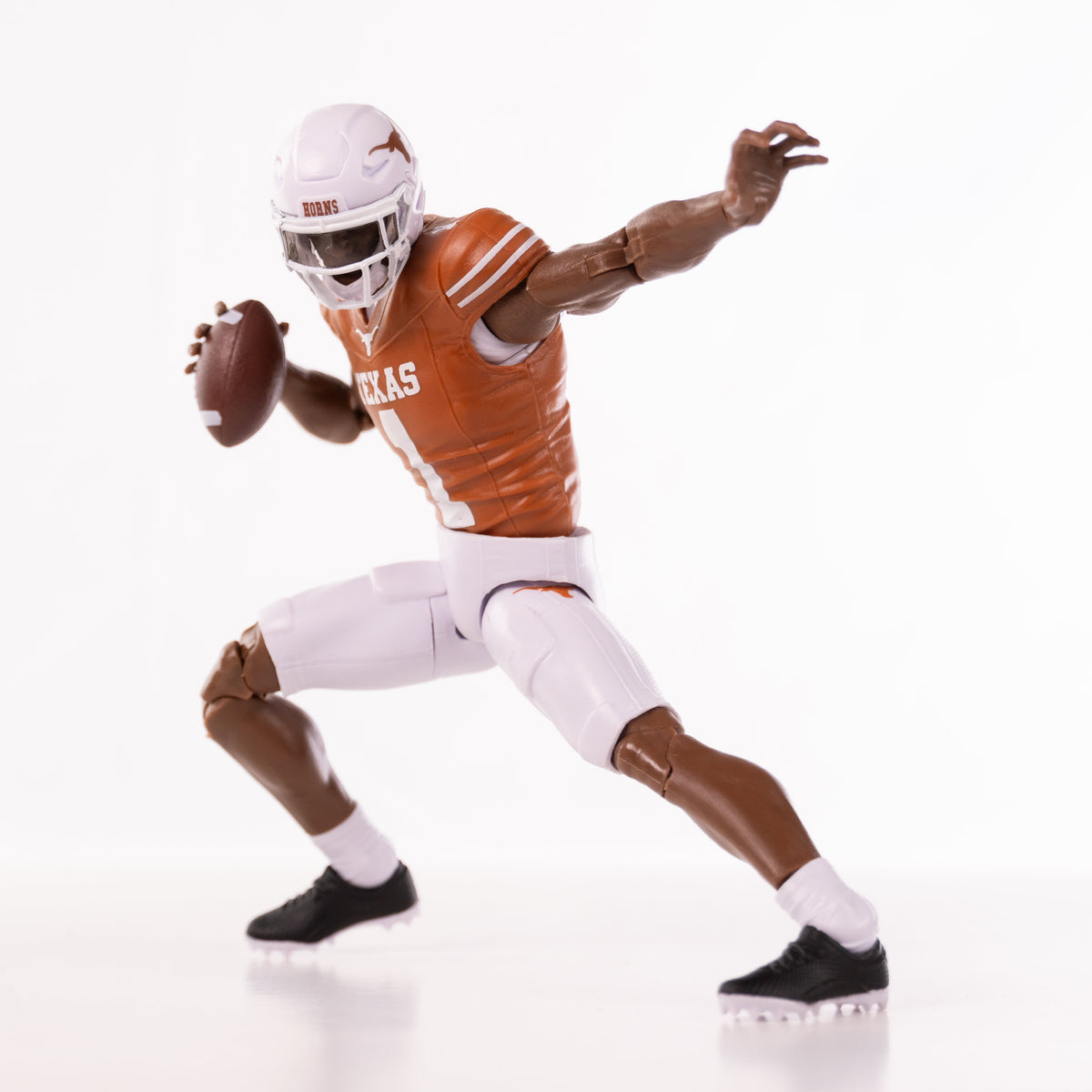 Collegiate Legends Texas football action figure in a burnt orange jersey and white pants throwing a football